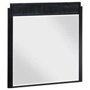 Complete your dresser with a stylish framed mirror. A perfect complement, it features a wooden frame complete with a fluted panel on top that adds rich depth and dimension. The mirror features a black finish with wire brushing that creates textural flair.