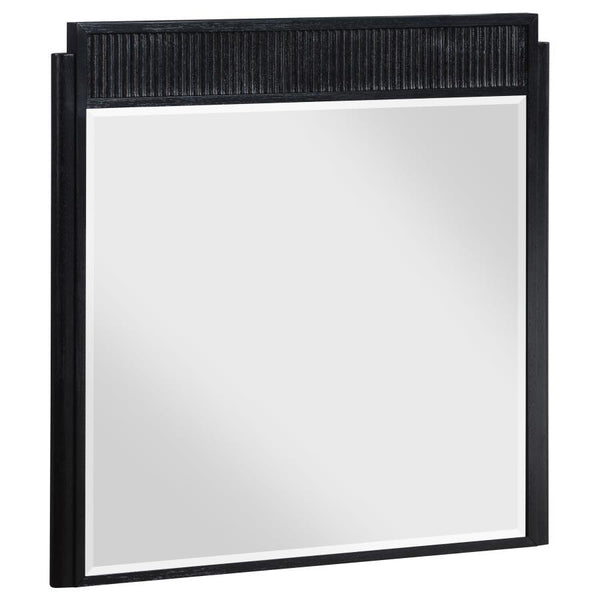 Complete your dresser with a stylish framed mirror. A perfect complement, it features a wooden frame complete with a fluted panel on top that adds rich depth and dimension. The mirror features a black finish with wire brushing that creates textural flair.