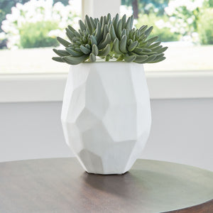  this vase brings ethereal beauty to your tabletop. Its white finish seamlessly harmonizes with existing accents. Meticulous craftsmanship creates the unique