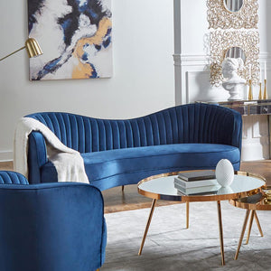  this retro-inspired sofa offers a striking curvy silhouette with a bold colored fabric. Wrapped entirely in a bright blue velvet that is super-soft to the touch