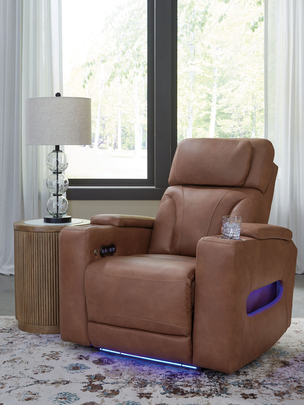 Ready to relax in style? Our luxurious power recliner doesn-'t just look fantastic â€“ it delivers creature comforts and fabulous functionality. An adjustable headrest ensures a perfect TV view no matter how far back you recline. Faux leather upholstery, 
