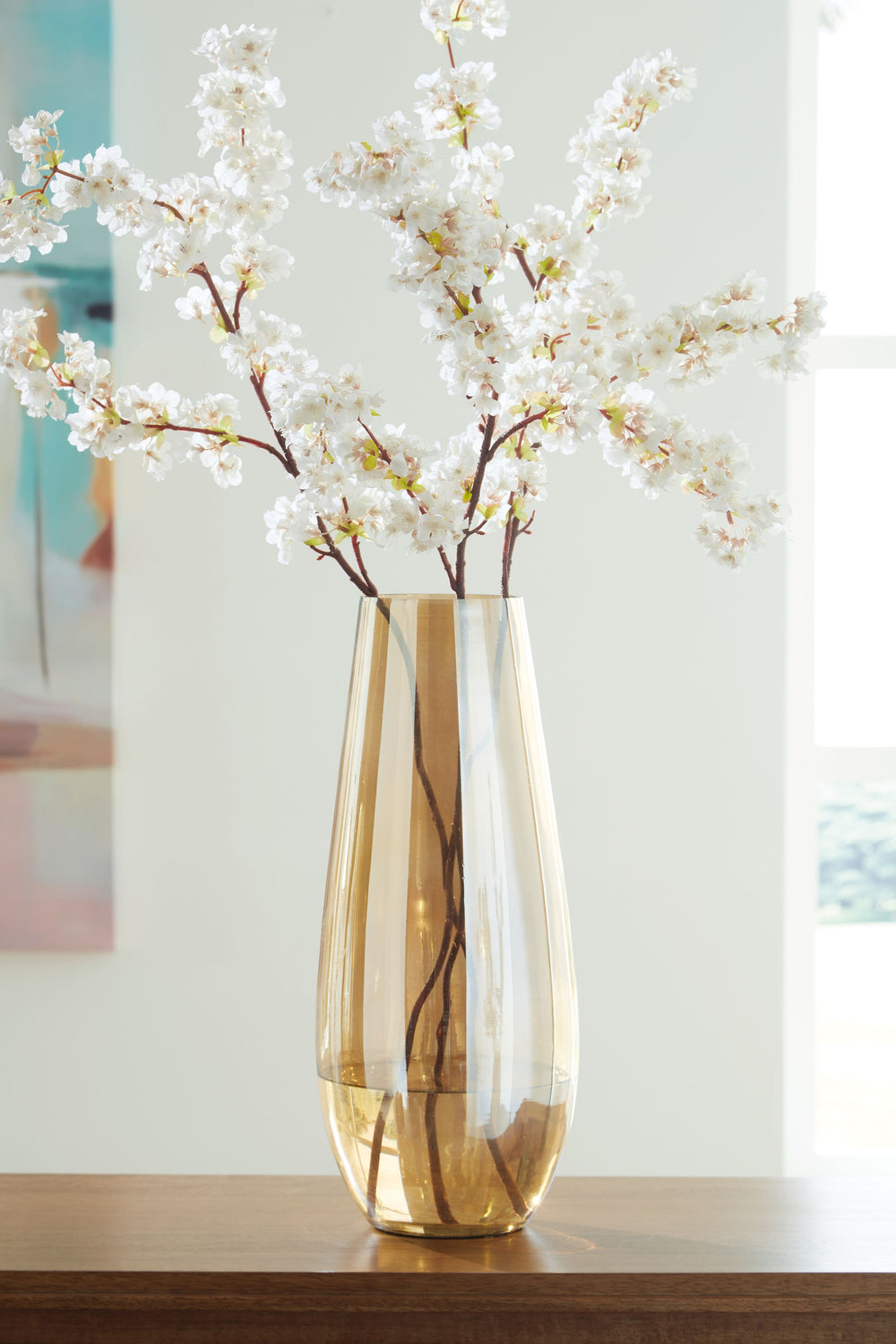 If you love contemporary style, youâ€™re sure to find this vase stunningly on point. Its shimmering amber finish and sleek shape are a feast for the eyes. This show-stopping vessel is gorgeous unadorned or filled with your favorite blooms whether they-'re