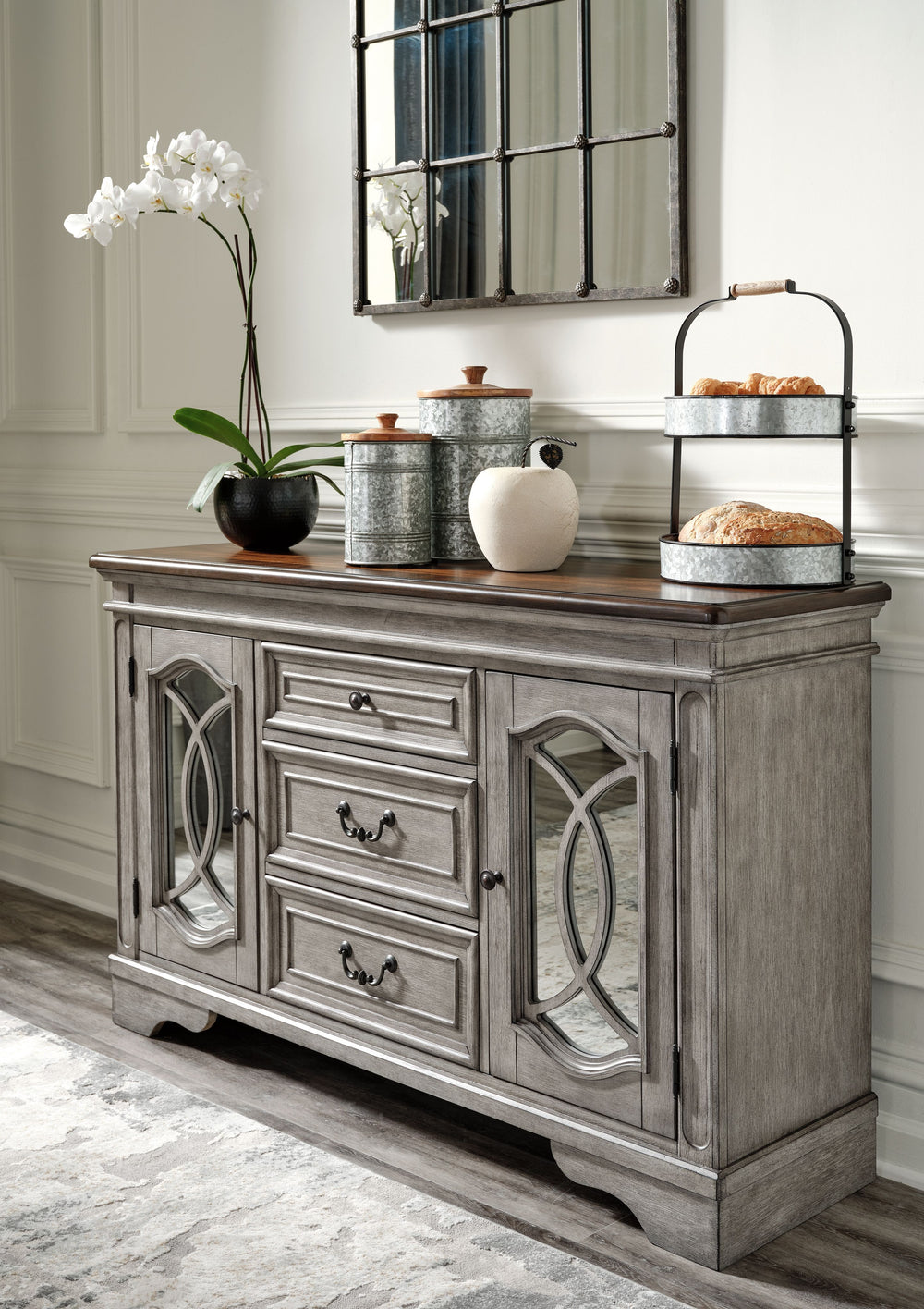 Serve up a sense of traditional cottage design with this dining room server. It features a pair of cabinet doors with inset mirrored glass and decorative fretwork. The server-'s three smooth-gliding drawers with dovetail construction and black felt bottom
