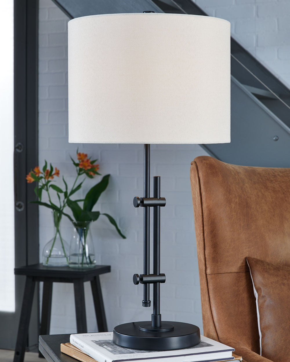 This metal desk lamp features a beautiful black finish that adds a rich accent to your living space. The lamp is elegantly engineered, and is adjustable to provide targeted illumination. Topped off with a crisp white drum shade, this lamp provides a subtl