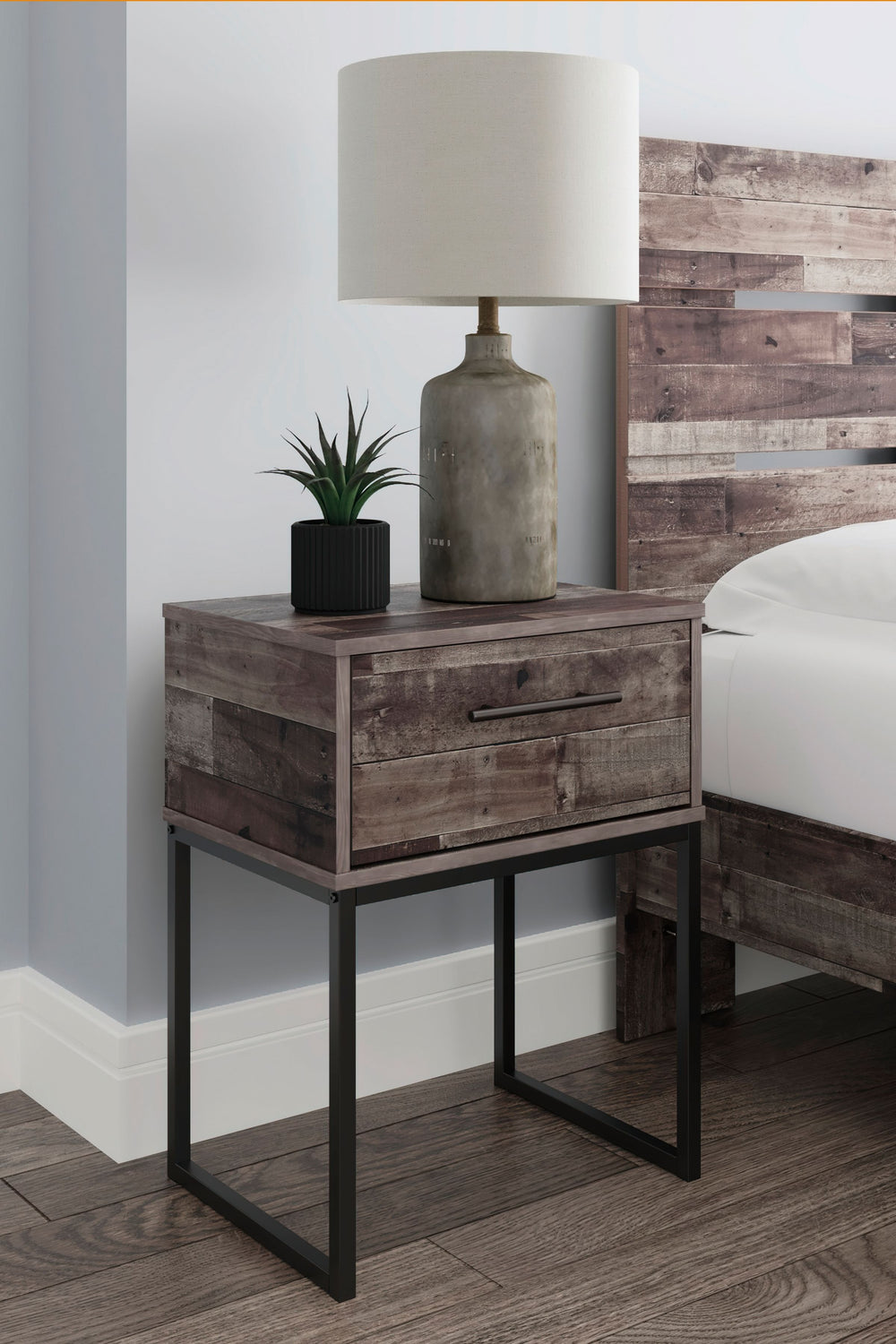 Streamlined design and a stunning finish come together in one simply extraordinary piece. This single drawer nightstand is sure to impress with canted metal legs and a rustic butcher block finish over replicated pine grain texture. Its mid-century profile
