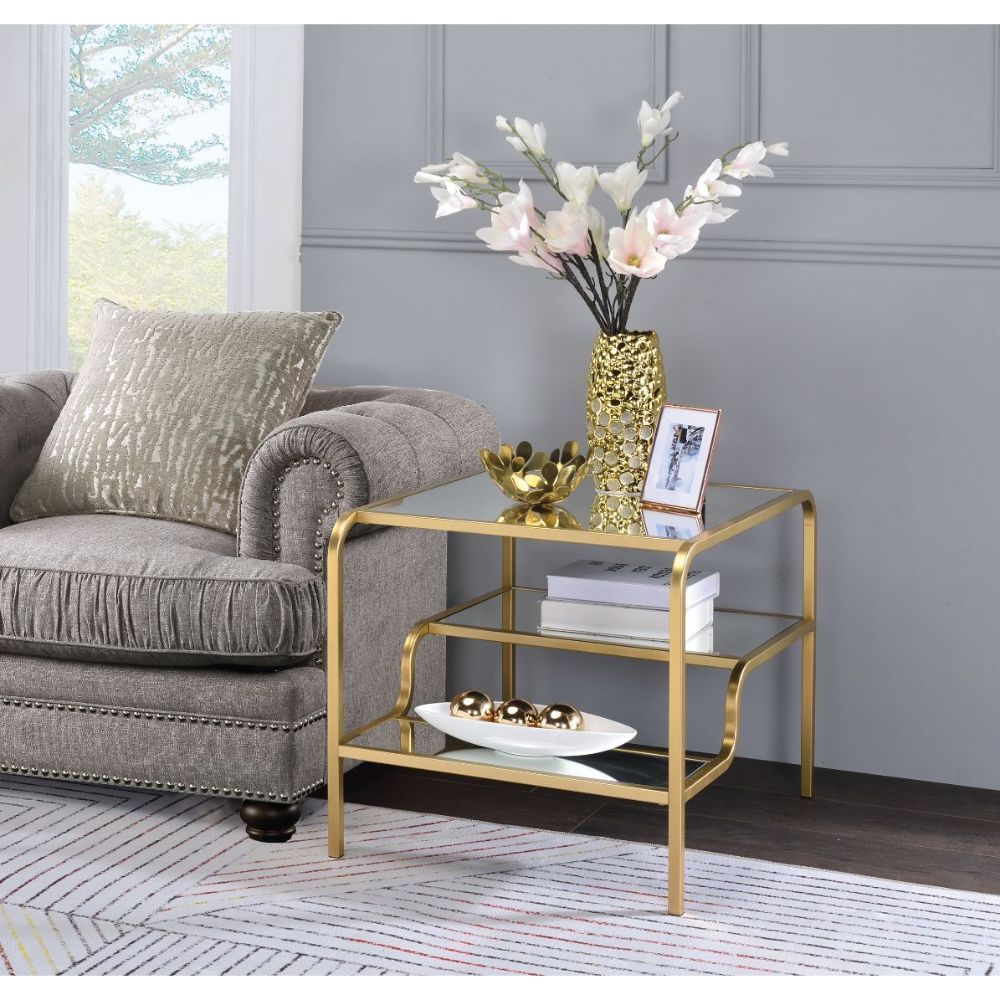 Center your seating arrangement around a sleek and sophisticated style with the Astrid occasional collection. Inspired by timeless materials, it features a mirror top with a stylish curving frame made of refined gold metal coating. An open base and floati