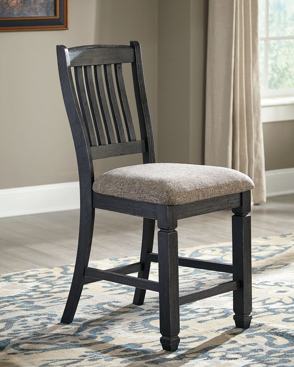 Invite your family into the heart of your home with this upholstered bar stool. Its framed back and tapered legs, in a beautifully textured black finish, provide a sturdy foundation. The stool-'s heavily woven fabric has a quality feel-good touch, while i