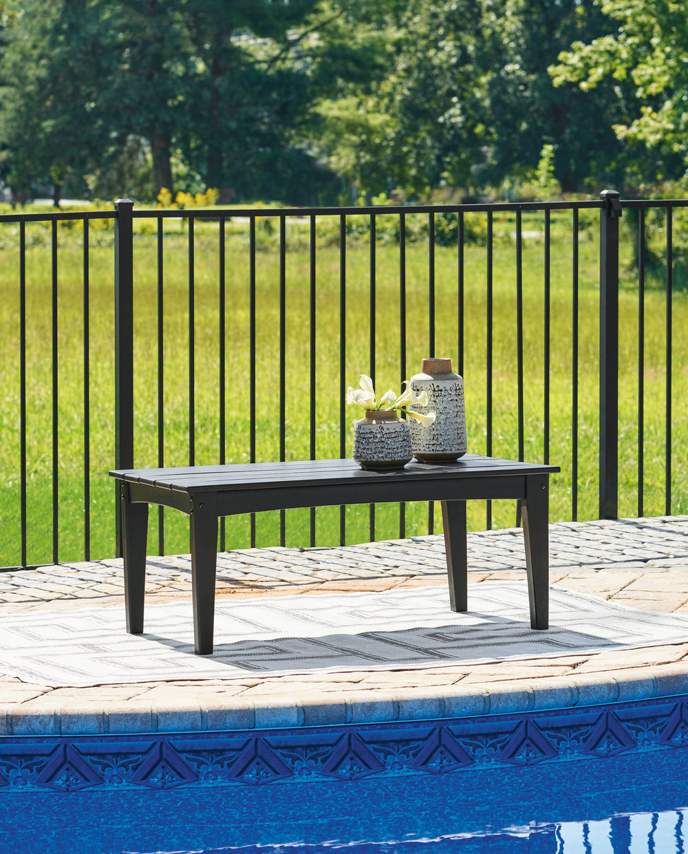 Drift into outdoor entertainment bliss with this coffee table. Dressed in a smart black for a sophisticated feel, it weathers sunny summer days and cozy winter nights with durable MEGA-TUFFÂ® HDPE material. When it comes to form and function, the table-'s