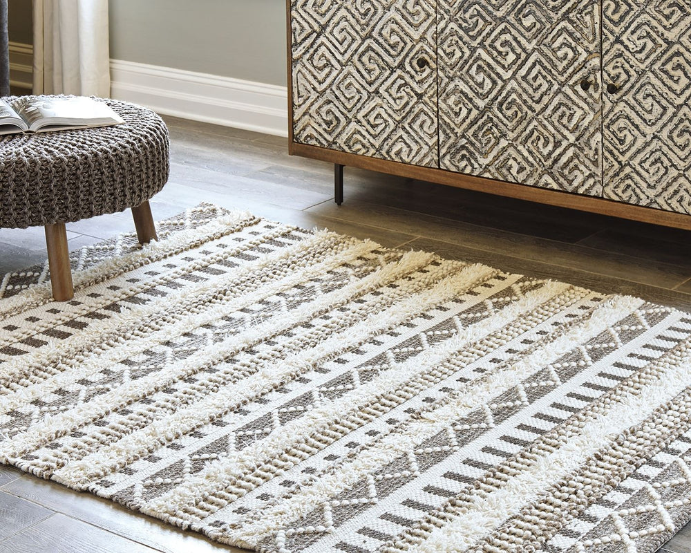Stay on trend with tribal chic. This area rug is just neutral enough to work with your decor and just cool enough to keep your space hip. Decorate again and again on top of this dynamic floor covering