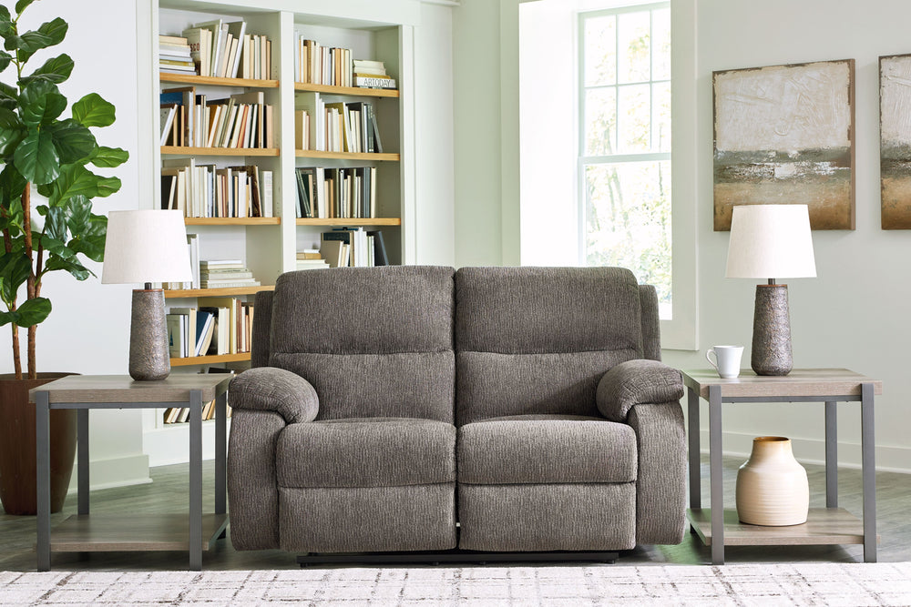 Craving a simple spot to relax and recharge? This reclining loveseat encourages you to take a break from the everyday grind. Its contemporary bustle back and versatile hue bring stylishly soft comfort to a seating area. And when youâ€™re ready to recline,