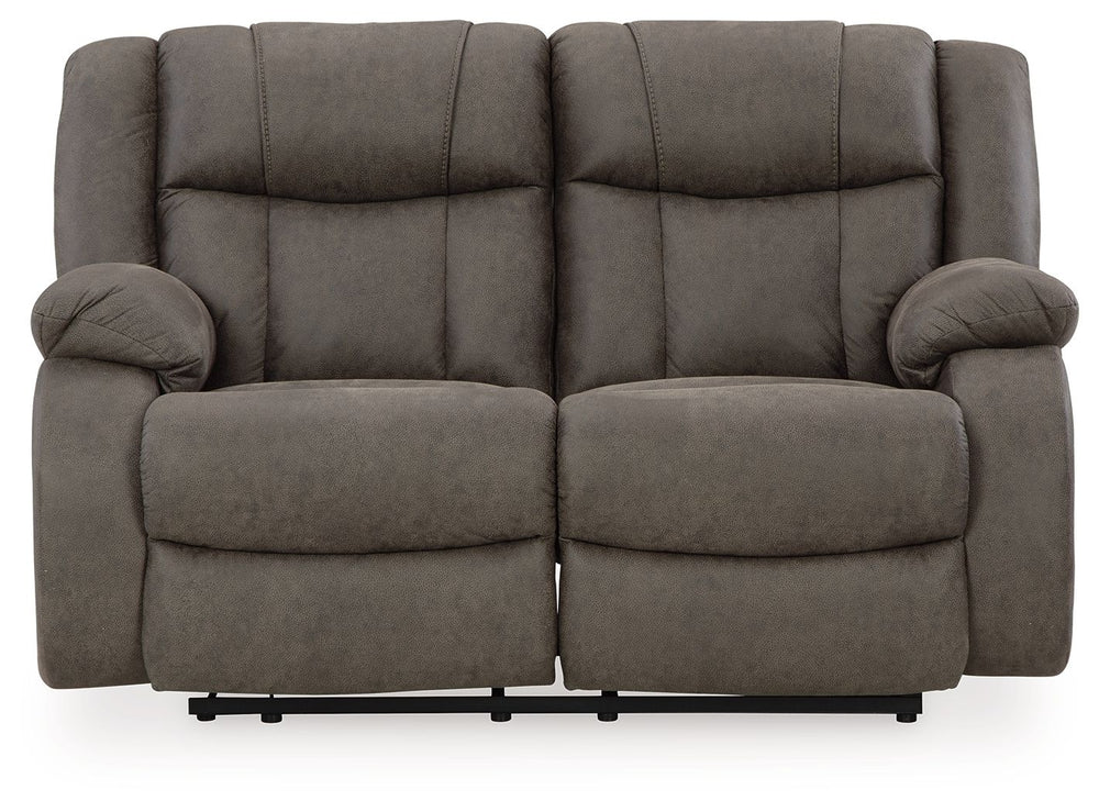 This loveseat tees you up to catch up on streaming or enjoy the latest game without breaking the bank. Its easy reclining motion and inviting stitched details craft a stylish seat that keeps you utterly at ease. And with a versatile neutral faux leather, 