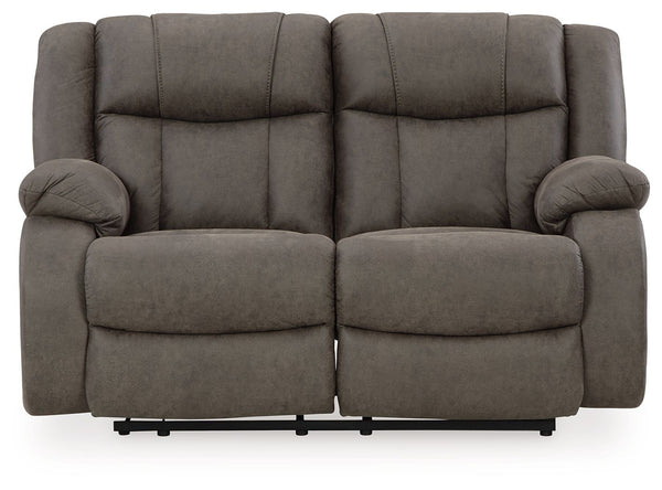 This loveseat tees you up to catch up on streaming or enjoy the latest game without breaking the bank. Its easy reclining motion and inviting stitched details craft a stylish seat that keeps you utterly at ease. And with a versatile neutral faux leather, 