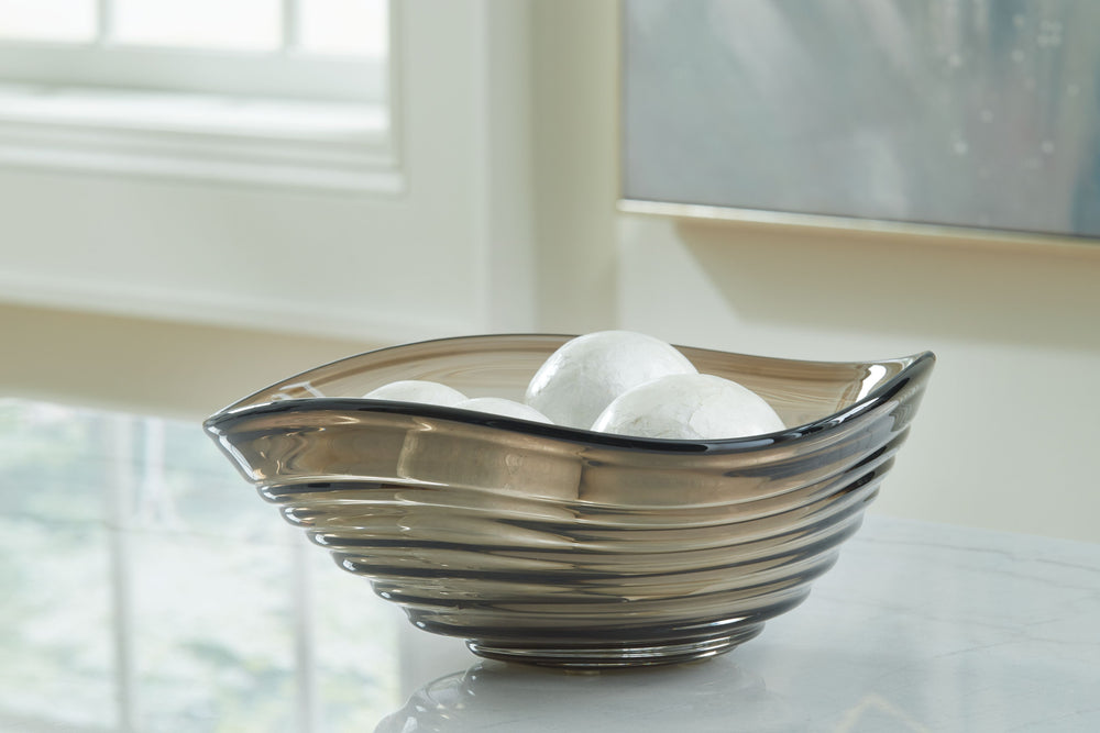 This bowl, with its taupe hue and organic sense of movement, is a graceful addition to contemporary spaces. Softly curved edges welcome whatever you toss inâ€”whether it displays decorative baubles or serves as a catch-all for entryway essentials. And the