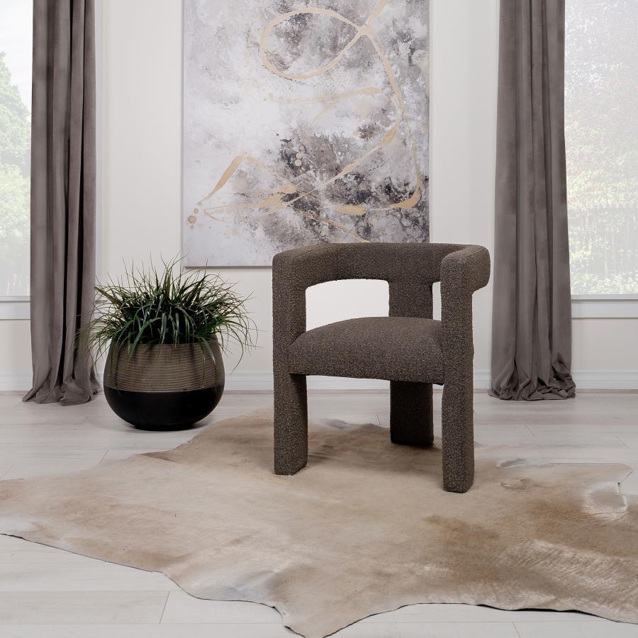 Enveloped entirely in the embrace of plush bouclÃ©, this chair redefines the art of relaxation with its all-fabric design. The seamless transition from the cushioned seat to the curved arms, all robed in the same soft fabric, creates a cocoon of comfort. 