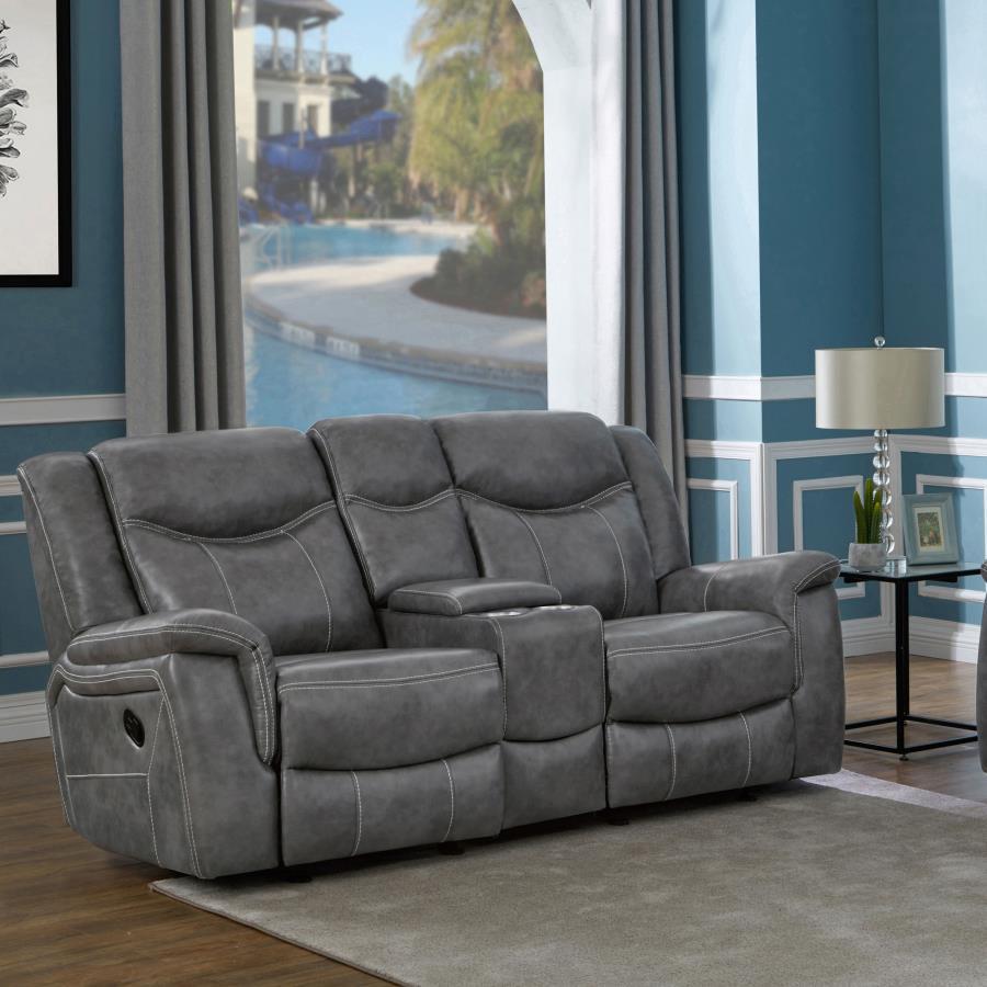 Grey is no longer drab and dreary and this decadent motion loveseat is proof. The angled seat backs feature extra padded headrests for optimal comfort. Padded armrests and recliner leg rest offer extra indulgence. Center console includes amenities like tw