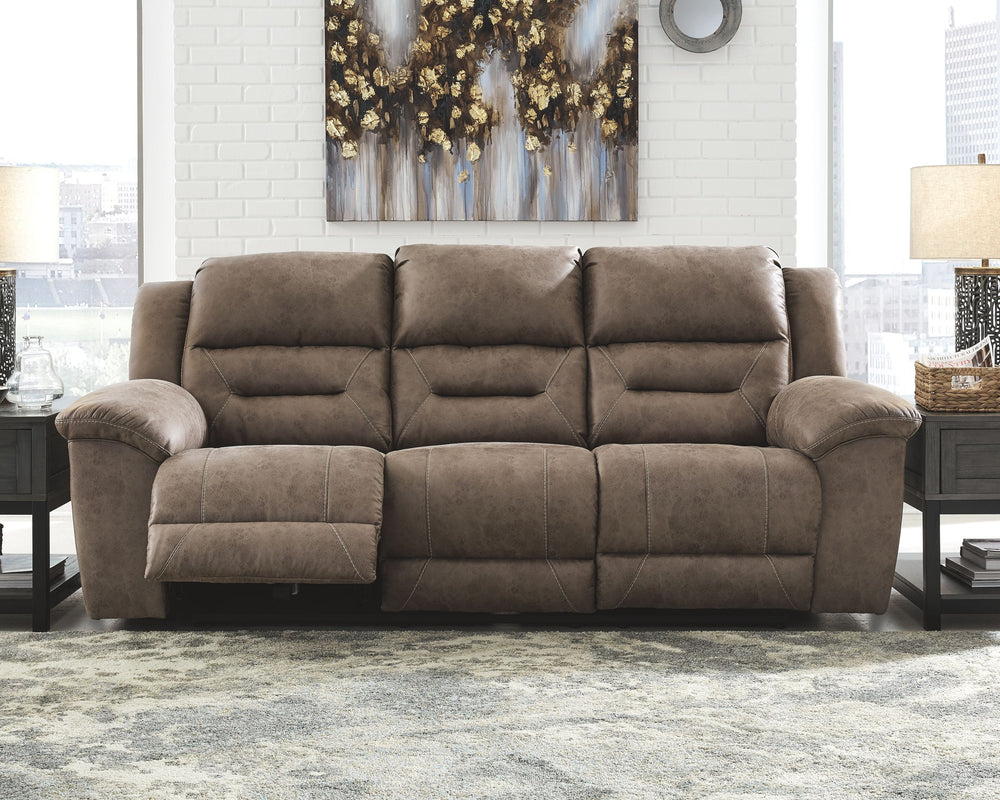 For those who love the cool look of leather but long for the warm feel of fabric, this reclining sofa delivers both with ease. Its high-performance padded faux leather is remarkably durable and easy to clean, making it just the thing for family spaces. Ch
