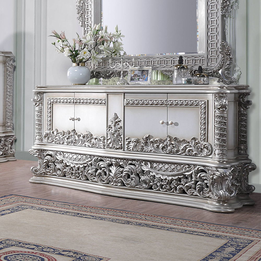 Characterized with button-tufted upholstery, intricate scrollwork, and lustrous finish, the Valkyrie Bedroom Collection provides the feeling of luxury and sophistication. Ornate carvings with floral scroll design on each piece boast extravagant silhouette