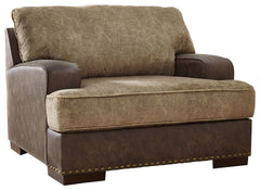 Oversized but not over-the-top, this chair is perfect for those who love the look of leather. Two textural tones provide twice the style and comfortâ€”and incorporate an added layer of visual interest. The piece is punctuated by a subtle band of nailhead 