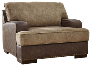 Oversized but not over-the-top, this chair is perfect for those who love the look of leather. Two textural tones provide twice the style and comfortâ€”and incorporate an added layer of visual interest. The piece is punctuated by a subtle band of nailhead 