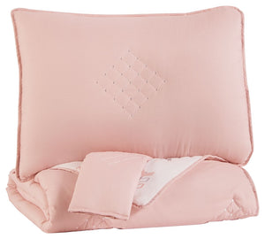 Bring a sophisticated look to your bedroom with this comforter set. Featuring a solid pink background with a stitched diamond design, the comforter reverses to a crisp and fresh arrow design in pink, white and grayâ€”giving you the choice to change up you