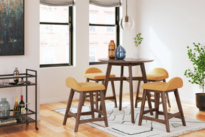 This counter-height dining set is a refreshed take on retro aesthetics. The counter table adds an air of playful simplicity to your dining space and the upholstered bar stool invites the eye with a soft-edged silhouette cushion. This set captures the arch