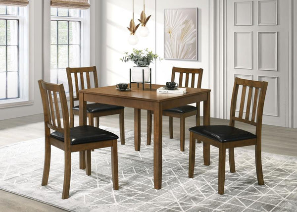 Perfectly sized for a breakfast nook or compact dining room, this contemporary five-piece dining set offers inviting style and a compact profile. The set centers on a square dining table crafted of wood with okume veneer in a stylish, neutral finish. Four