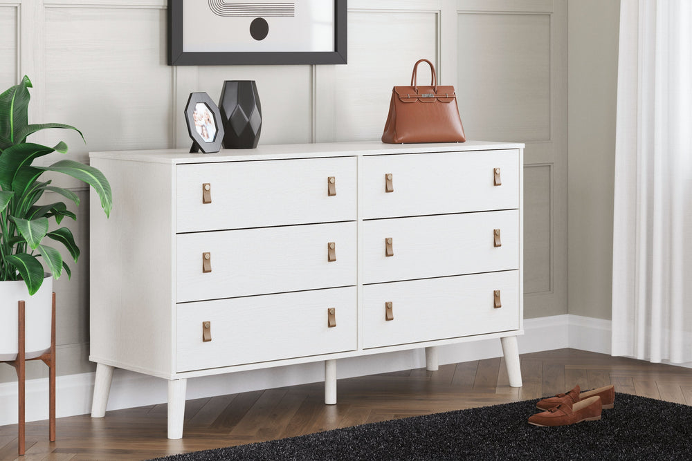 Dare to take minimalism to the max. This dresser has an air of sleek simplicity thanks to its white painted finish with subtle replicated wood grain. The magnificently mod splay legs are a compelling complement to its streamlined design. And with two sets