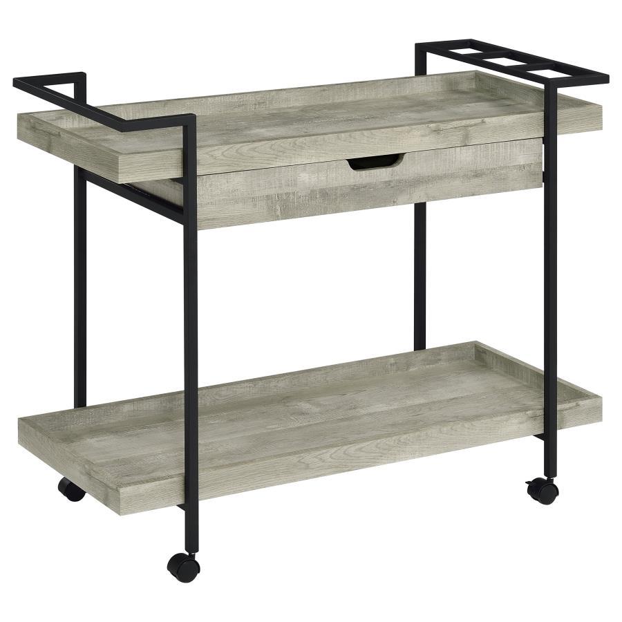 Speakeasy charm meets modern farmhouse in a delightful mobile bar cart. Whether you-'re mixing cocktails or pouring a favorite vintage, the cart offers plenty of space for both storage and prep with a tray-style top and shelf, plus a drawer ideal for acce