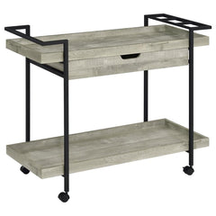 Speakeasy charm meets modern farmhouse in a delightful mobile bar cart. Whether you-'re mixing cocktails or pouring a favorite vintage, the cart offers plenty of space for both storage and prep with a tray-style top and shelf, plus a drawer ideal for acce