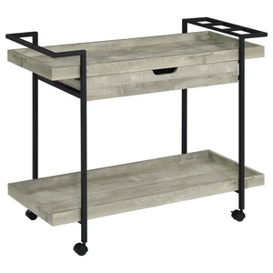 Speakeasy charm meets modern farmhouse in a delightful mobile bar cart. Whether you-'re mixing cocktails or pouring a favorite vintage, the cart offers plenty of space for both storage and prep with a tray-style top and shelf, plus a drawer ideal for acce