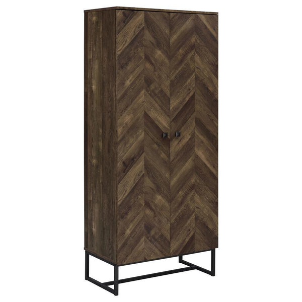 This tall storage cabinet blends rustic charm with modern utility, featuring a rustic oak finish and herringbone-patterned door fronts. Made from engineered wood with a scratch-resistant and eco-friendly laminate veneer, it includes multiple fixed shelves