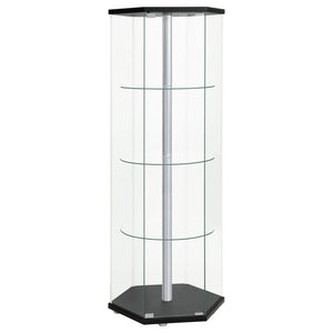 Explore the cutting edge properties of geometric design. Made from glass, this curio cabinet wakes up a contemporary space and puts a new spin on an old classic. Hexagonal in shape, it features a cool center pole for visual effect. A black finish top and 
