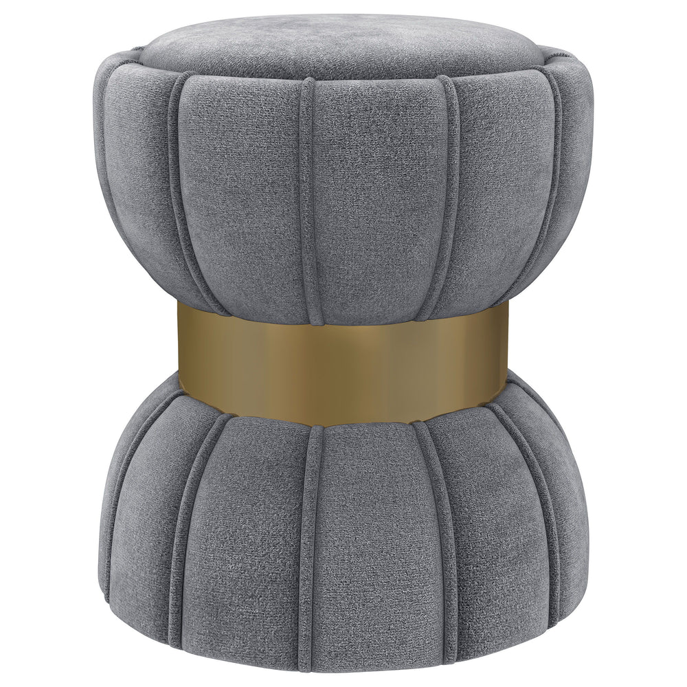 Put finishing touches on a chic decor with a modern glam ottoman. Its hourglass silhouette is playful and elegant, with a wide band highlighting in a bright gold finish. The round ottoman is a compact addition, offering a perfect spot to prop your feet. I