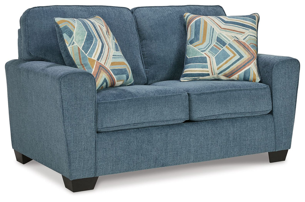 Need a simple style refresh? Liven up your living room essentials with this loveseat. A chunky silhouette holds invitingly ample cushioning you-'ll long to lounge in. Crosshatched upholstery and accent pillows give the otherwise casual design a delightful