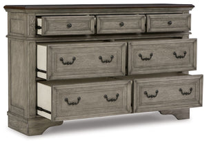  deep walnut on the top. Framed drawer fronts and dark bronze-tone hardware marry classic 