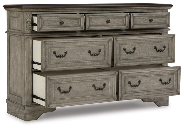  deep walnut on the top. Framed drawer fronts and dark bronze-tone hardware marry classic 