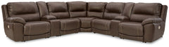 Load up on comfort in a cool, clean-lined and contemporary way with this power reclining sectional in chocolate brown. Rest assured, the expertly matched leather and faux leather upholstery is enriched with a pebble grain effect for authentic appeal and e