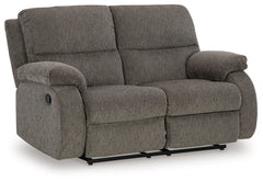 Craving a simple spot to relax and recharge? This reclining loveseat encourages you to take a break from the everyday grind. Its contemporary bustle back and versatile hue bring stylishly soft comfort to a seating area. And when youâ€™re ready to recline,