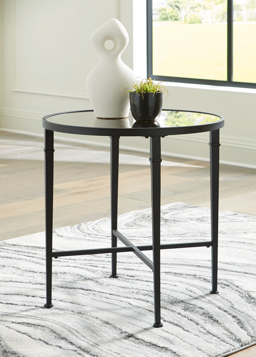 Pair your sofa or favorite armchair with this accent table. The round frame houses a stunning antiqued mirrored top for a touch of glamour and finesse. And the table-'s open concept exudes a sense of luxury, making it a standout wherever itâ€™s placed. Yo