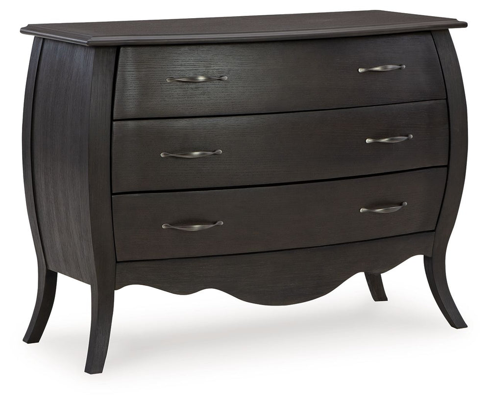 Beautiful curving lines and charming vintage flair give this cabinet its elegant antique feel. The dark finish is accented with silvertone drawer pulls, while three drawers ensure a smooth motion for your storage needs. What a charming complement to your 