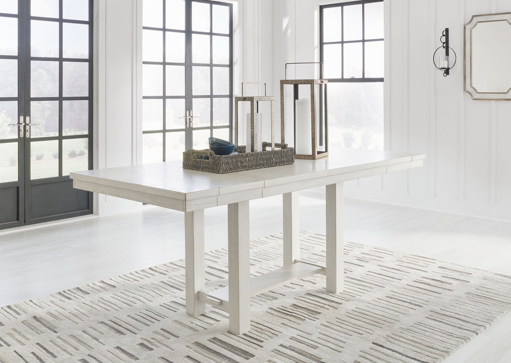 This counter height dining table is sure to impress come mealtime. With its antiqued white finish and a planked effect tabletop that extends for additional seating, farmhouse-style dining has never been so fashionable. All thatâ€™s missing is you and your