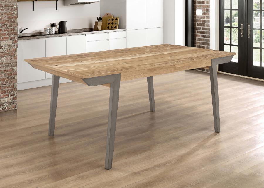 A classic farmhouse design gets a modern update in this gorgeous, wooden dining table. This tasteful piece boasts a spacious, rectangular surface with plenty of room to spread out. The top showcases natural wood grains for a cool, country vibe. A grey leg