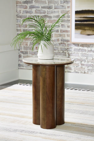  appealing to the luxurious but inviting vibe of your contemporary aesthetic. A beige marble top pairs with cylindrical legs in a brown finish