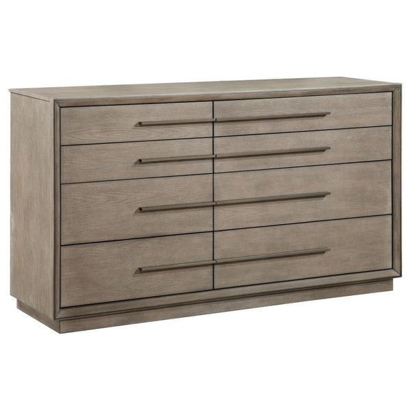 An asymmetric centerline creates a touch of artistry for this transitional eight-drawer dresser. Designed for spacious storage of clothing and accessories, it features drawers of varying sizes, creating easy organization. A Taupe oak wood finish is soft a