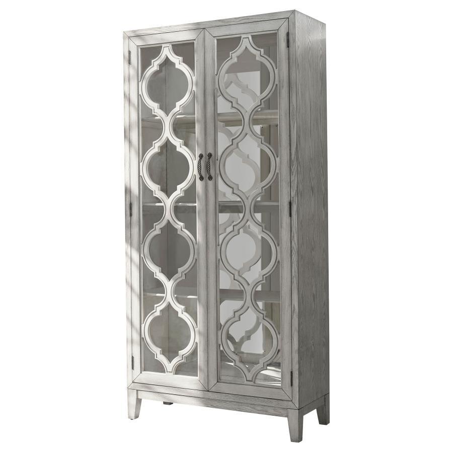 Showcase your cherished items in this striking display cabinet, crafted with intricate lattice wood overlay and mirrored back panels for added depth and elegance. Framed glass doors open to reveal three shelves ideal for displaying collectibles or dinnerw