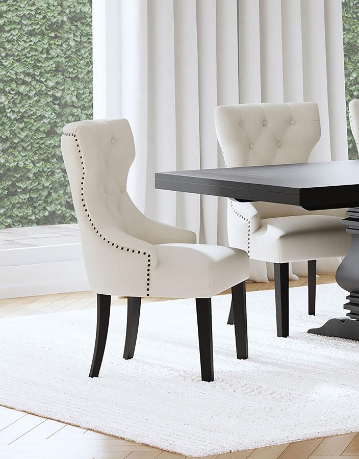 Create an exceptional, inviting dining room space with a modern button tufted dining chair. It pairs a classic wingback profile with a gentle curvature, offering impeccable comfort and chic style. Its plush back and seat feature foam cushioning with soft 