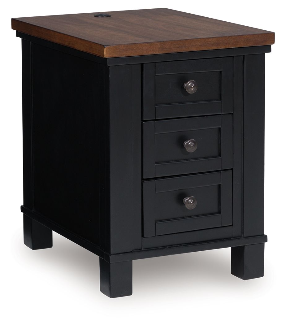 Raise the bar on modern farmhouse style with this chairside end table. Its sturdy silhouette and casual good looks are accentuated with a two-tone finish, which pairs a warm satin black base with a contrasting butcher block veneer top. Spacious storage dr