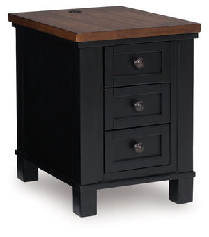 Raise the bar on modern farmhouse style with this chairside end table. Its sturdy silhouette and casual good looks are accentuated with a two-tone finish, which pairs a warm satin black base with a contrasting butcher block veneer top. Spacious storage dr
