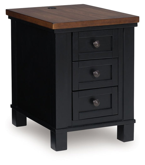 Raise the bar on modern farmhouse style with this chairside end table. Its sturdy silhouette and casual good looks are accentuated with a two-tone finish, which pairs a warm satin black base with a contrasting butcher block veneer top. Spacious storage dr