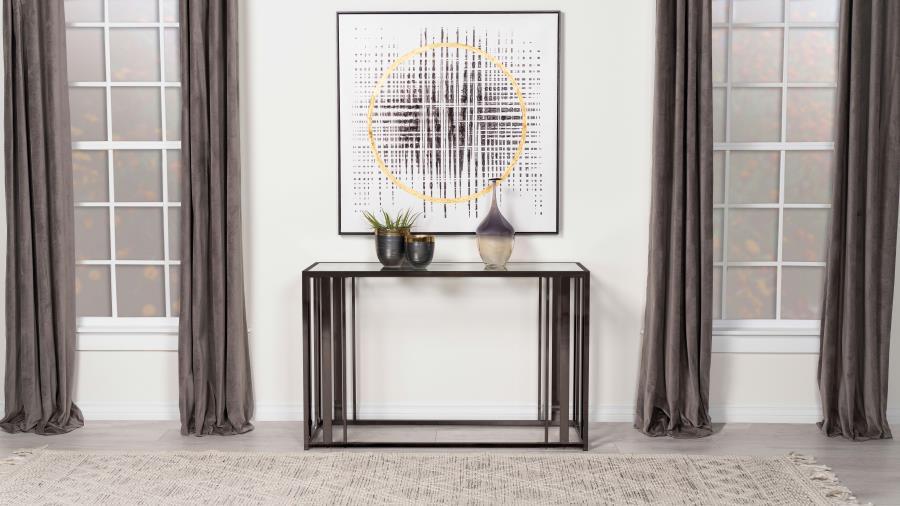 This modern rectangular console table features a clear tempered glass top paired with a geometric base crafted from heavy-gauge metal with a sleek electroplated finish. The open design creates a contemporary aesthetic, offering both elegance and durabilit